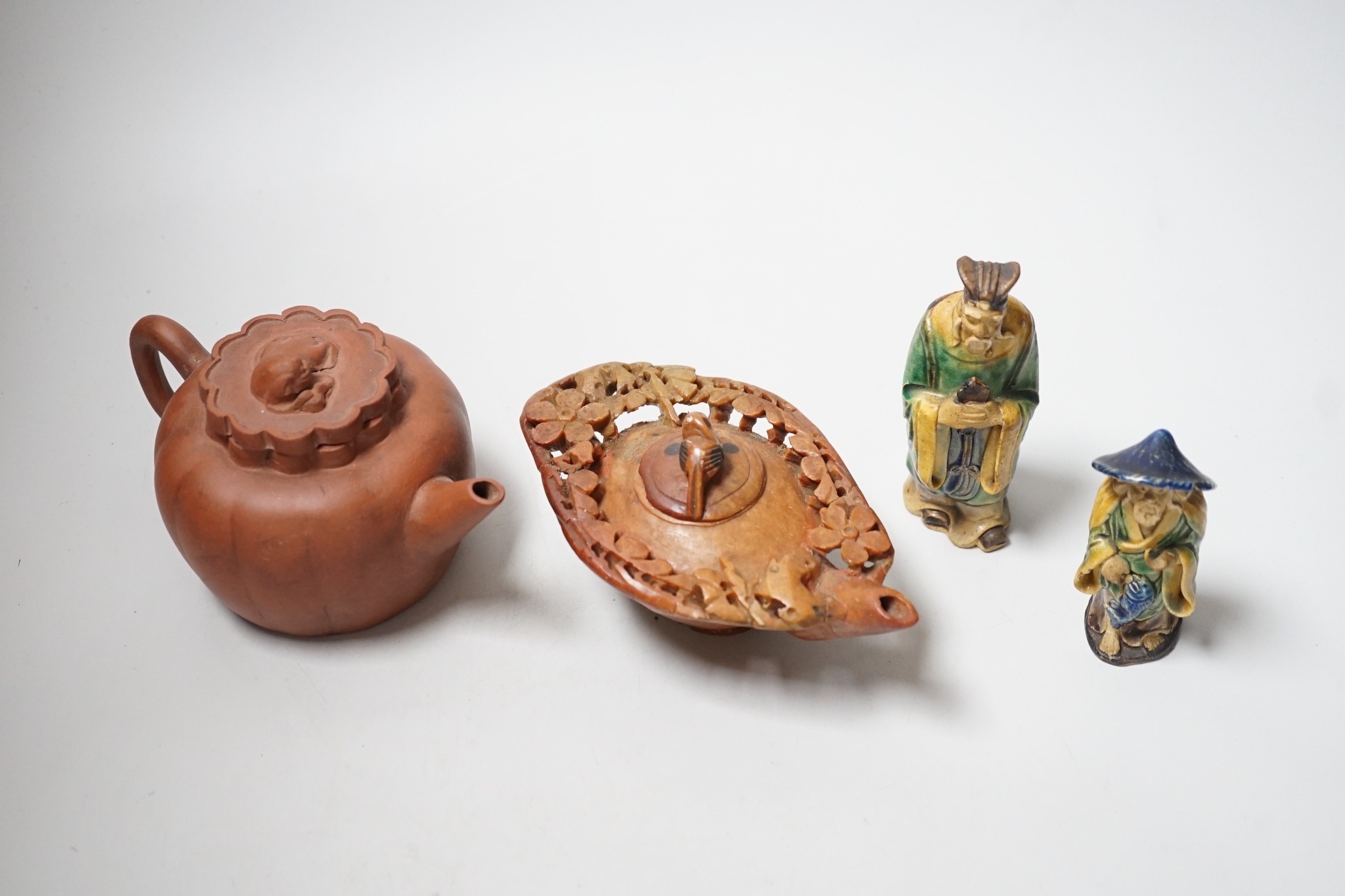 A Chinese carved soapstone pot, a terracotta teapot, and two earthenware figures, tallest figure 11cms high